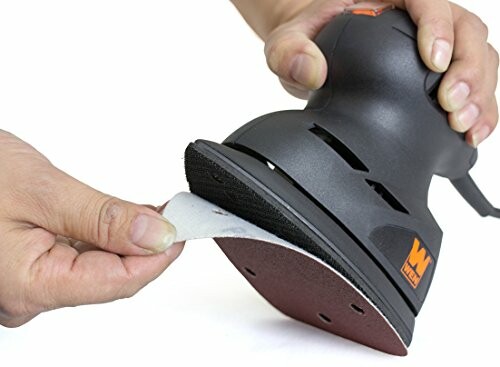 Person attaching sandpaper to a hand-held orbital sander.