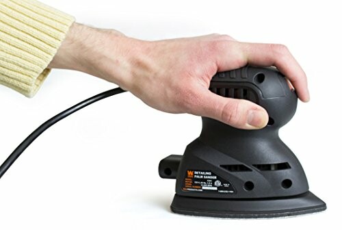 Person holding a black electric sander.