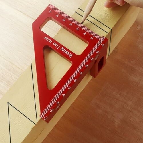 Red carpenter square tool used for precise measurements on wood.