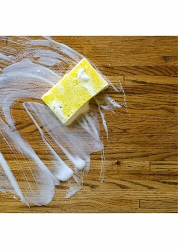 Yellow sponge on soapy wood floor