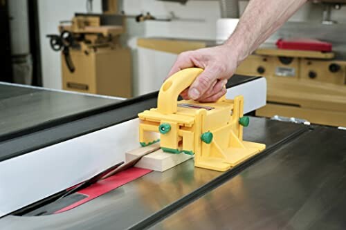 Person using a safety tool on a table saw