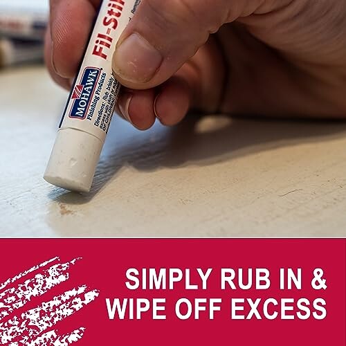 Hand using a fill stick on wood surface with text 'Simply rub in & wipe off excess'.