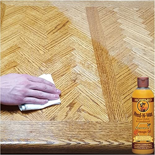 Hand applying wood polish on a wooden table next to a bottle of Feed-N-Wax.